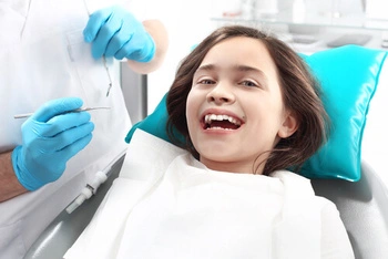smiling girl patient on a dental chair
