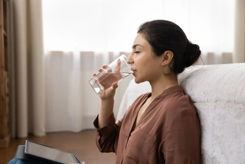 woman drinking plenty of water